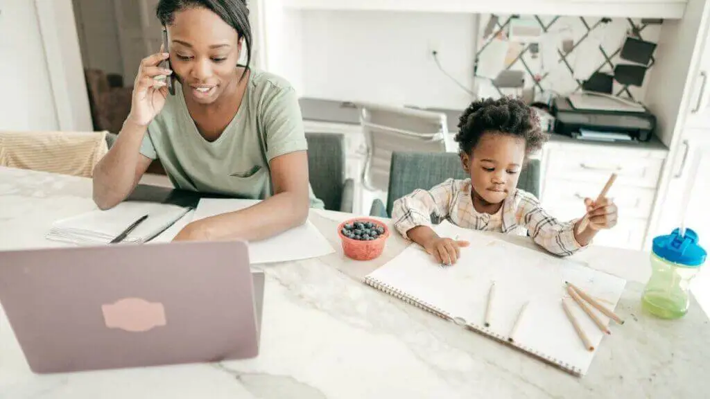 a woman and child working at a table