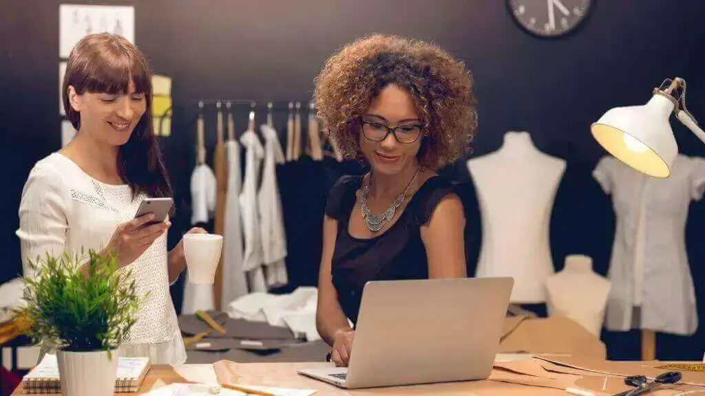 a woman looking at a laptop